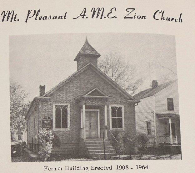 Black-and-white photo of the old brick church on Rowan Street, with a small bell tower and arched windows