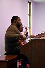 A staff member at the keyboard during worship