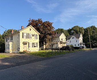 The church’s neighbouring houses along the street on a sunny day