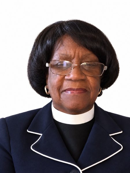 Rev. Ruby Bell in a navy blazer and clerical collar